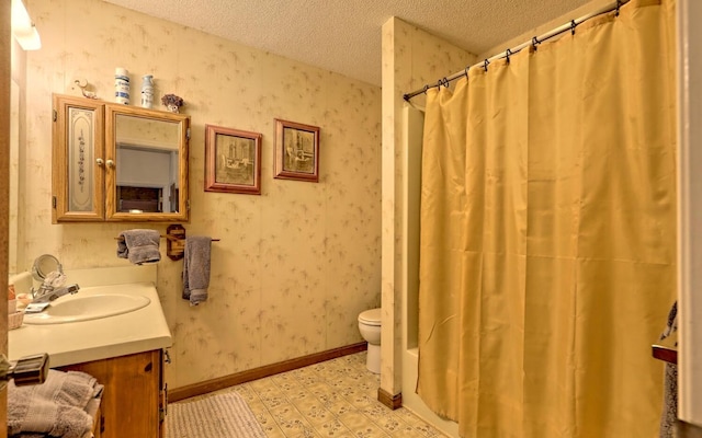 bathroom featuring a textured ceiling, vanity, toilet, and curtained shower