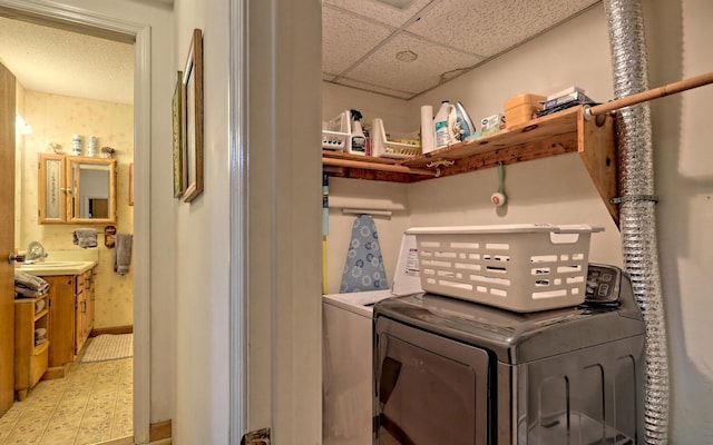 washroom featuring washing machine and dryer and sink