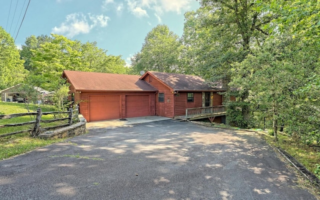 log-style house with a garage and a deck