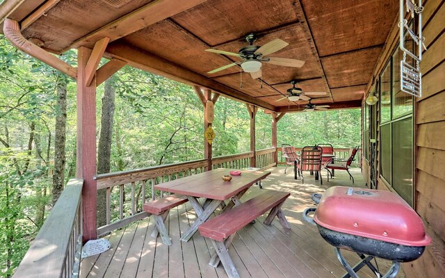 wooden deck with ceiling fan and a grill