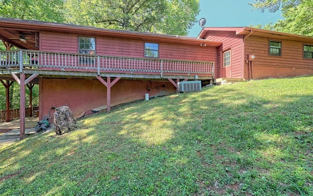 back of house with central AC, a yard, and a deck