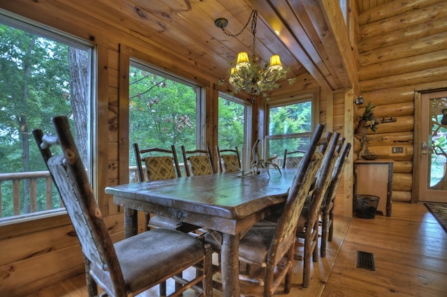 dining area featuring hardwood / wood-style floors and a notable chandelier