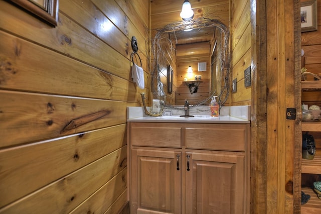 bathroom featuring vanity and wood walls