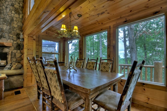 dining area with wood ceiling, a chandelier, and light hardwood / wood-style flooring