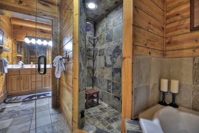 bathroom with wooden walls, shower with separate bathtub, and vanity