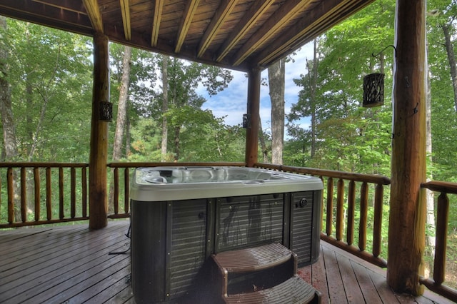 wooden deck featuring a hot tub