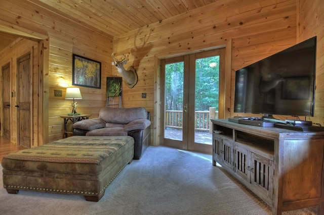 carpeted living room with french doors, wood walls, and wood ceiling