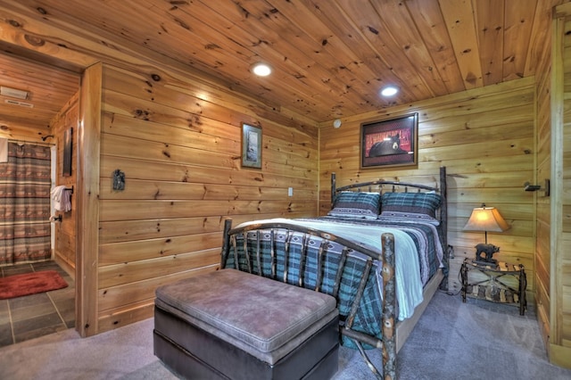 carpeted bedroom with wood ceiling and wood walls