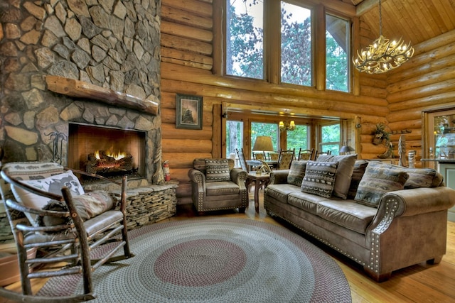 living room featuring a fireplace, light hardwood / wood-style flooring, a chandelier, a high ceiling, and rustic walls