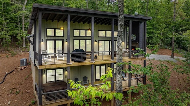 rear view of property with central air condition unit and french doors