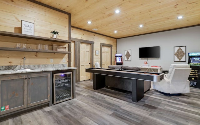 interior space featuring hardwood / wood-style flooring, wine cooler, and sink