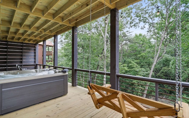 wooden deck featuring a hot tub