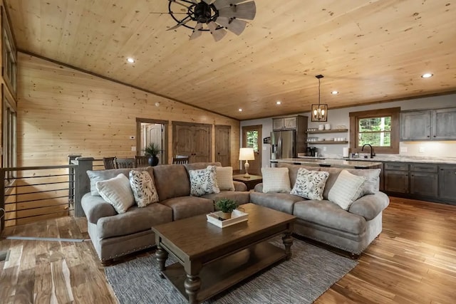 living room featuring light hardwood / wood-style floors, vaulted ceiling, and wood ceiling