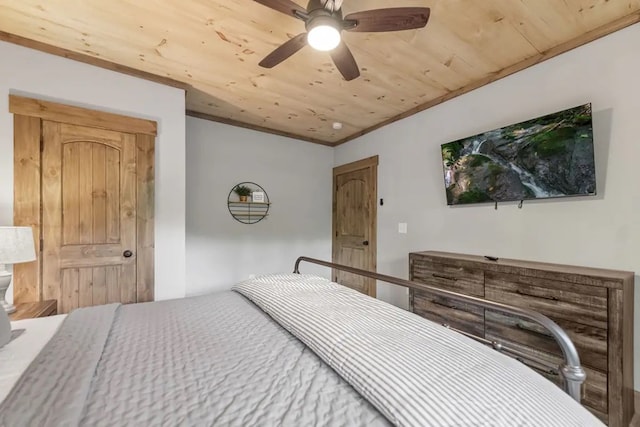 bedroom with ceiling fan, crown molding, and wood ceiling