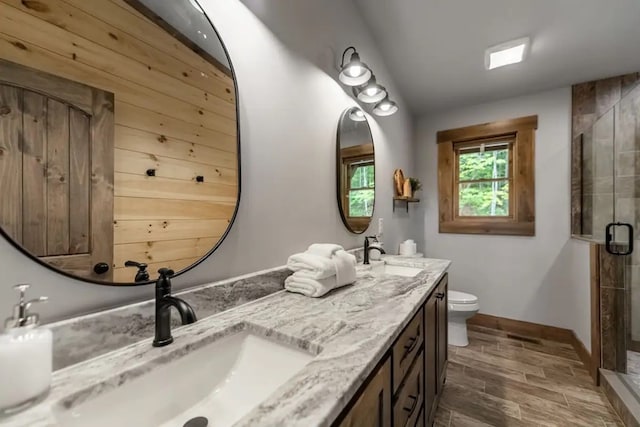 bathroom with hardwood / wood-style floors, vanity, an enclosed shower, and toilet