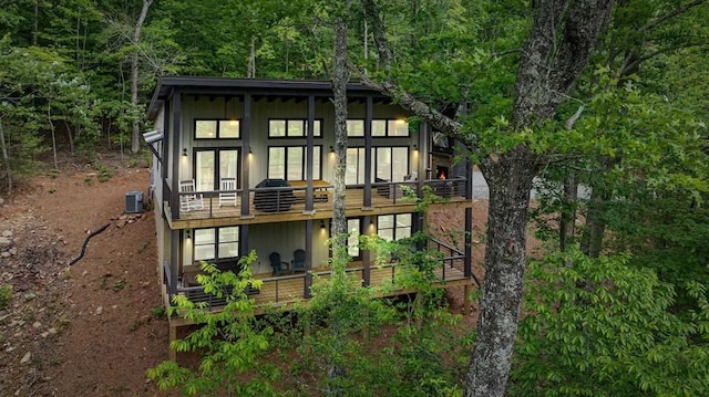 back of house featuring a deck and central air condition unit