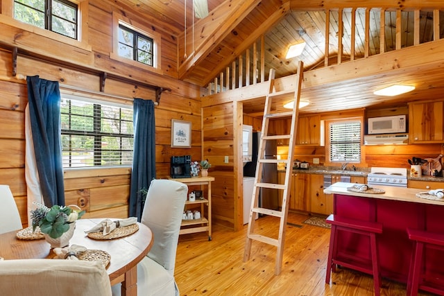 106 River Vista Dr, Dillard, GA 30537 - dining area featuring healthy amount of natural light, wooden walls, light wood finished floors, high vaulted ceiling, and a wood ceiling with exposed beams