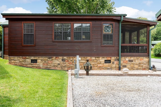 106 River Vista Dr, Dillard, GA 30537 - view of front facade with crawl space, a front yard, and a sunroom