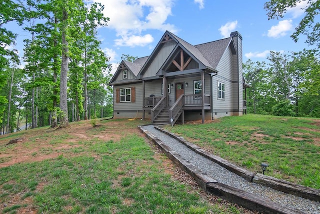 view of front of property with crawl space, a chimney, a front lawn, covered porch, and board and batten siding