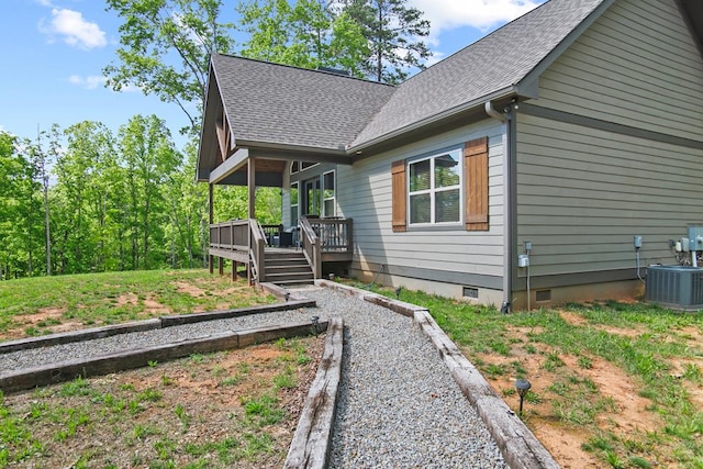 view of front of house with crawl space, a wooden deck, a shingled roof, and cooling unit