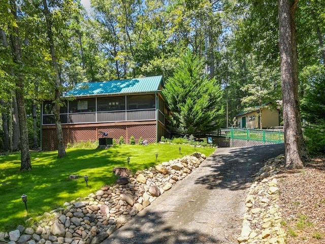 exterior space featuring a sunroom and a front yard