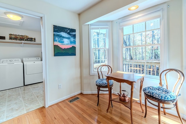 living area featuring light wood-type flooring and washing machine and clothes dryer