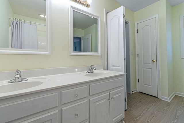 bathroom featuring vanity and wood-type flooring