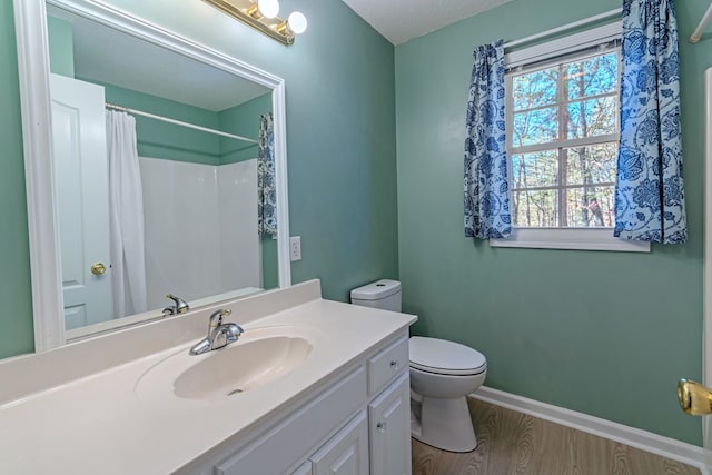 bathroom with vanity, a textured ceiling, hardwood / wood-style floors, toilet, and curtained shower