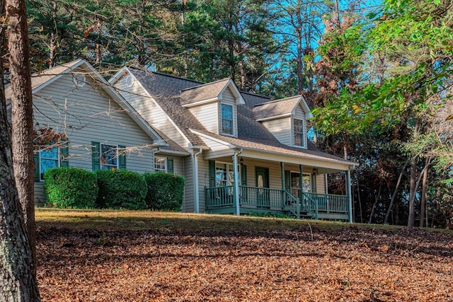 cape cod home featuring covered porch