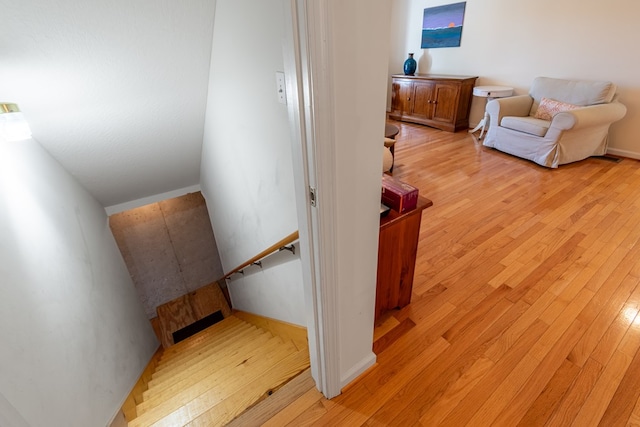 stairs featuring hardwood / wood-style floors