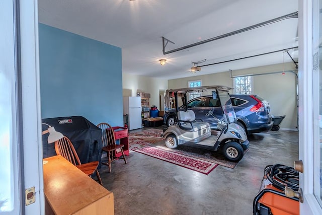 garage with white fridge and a garage door opener