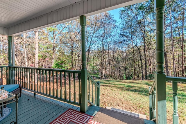 wooden terrace with a yard and a porch