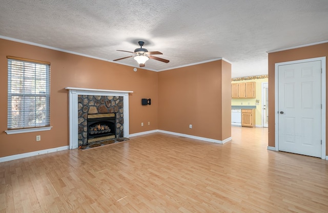 unfurnished living room with a fireplace, light hardwood / wood-style flooring, a textured ceiling, and ornamental molding