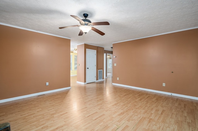 empty room featuring ceiling fan, light wood-type flooring, a textured ceiling, and ornamental molding