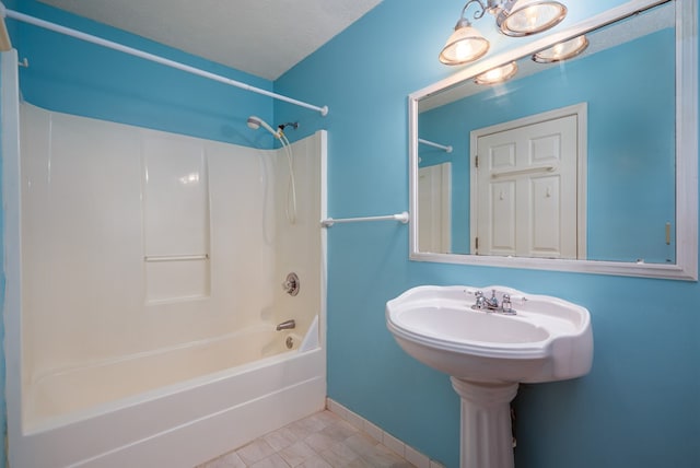 bathroom featuring tile patterned flooring, shower / bathtub combination, and a textured ceiling