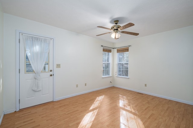 entryway with ceiling fan, a textured ceiling, and light wood-type flooring