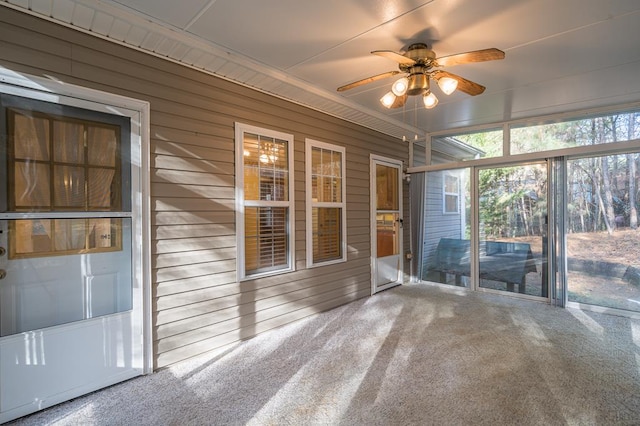 unfurnished sunroom featuring ceiling fan