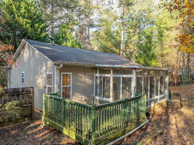 back of property with a sunroom