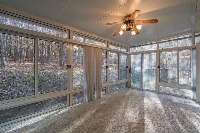 unfurnished sunroom with ceiling fan and a healthy amount of sunlight