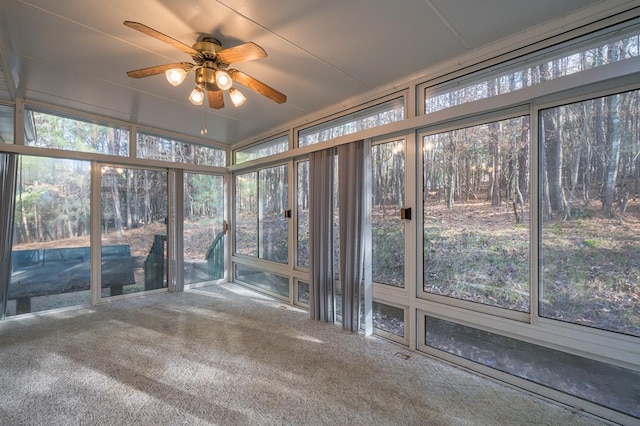 unfurnished sunroom with ceiling fan