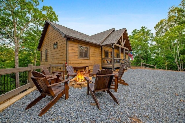 back of house featuring an outdoor fire pit