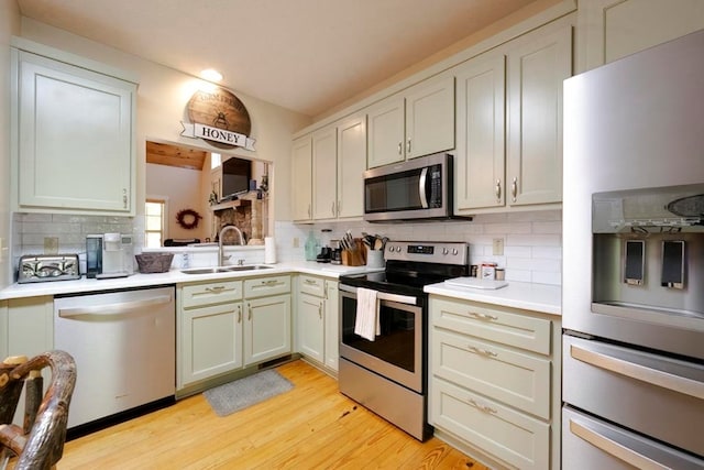 104 E Buck Run, Dahlonega, GA 30533 - kitchen featuring appliances with stainless steel finishes, tasteful backsplash, light countertops, light wood-style flooring, and recessed lighting