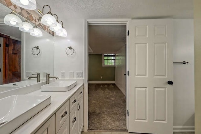 bathroom featuring a textured ceiling and vanity