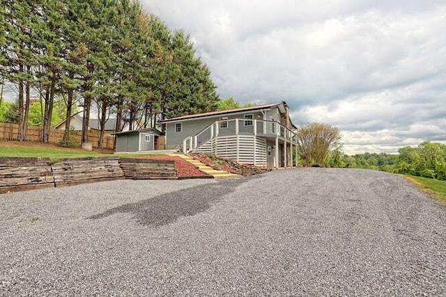 view of side of home featuring a shed