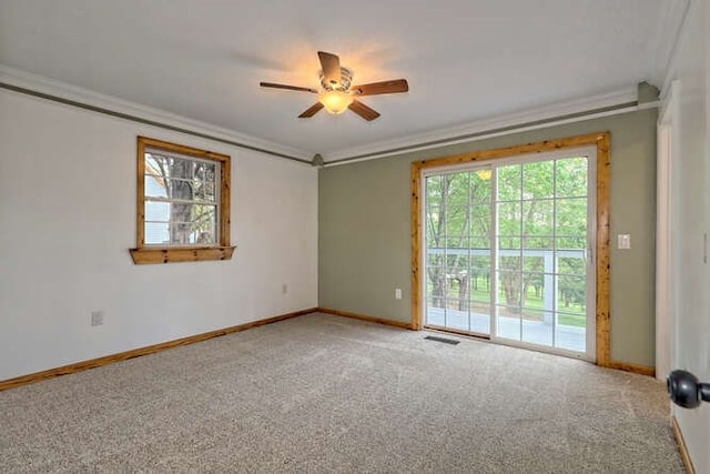 empty room featuring carpet, ornamental molding, and ceiling fan