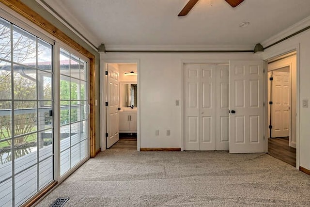 unfurnished bedroom with ceiling fan, access to outside, ornamental molding, carpet flooring, and ensuite bath