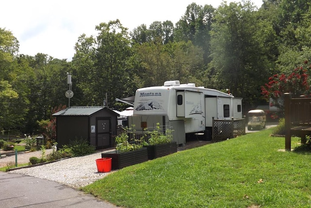 view of property exterior featuring a yard and a shed