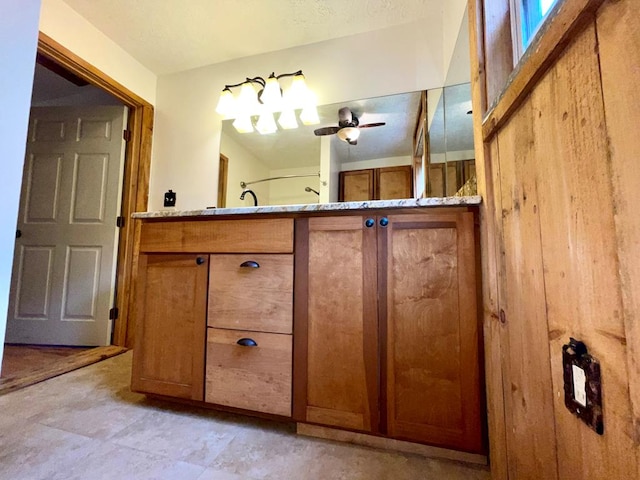 bathroom with ceiling fan and vanity