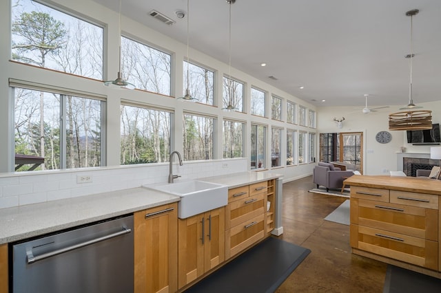 1181 Tickanetley Rd, Ellijay, GA 30536 - kitchen with stainless steel dishwasher, finished concrete floors, open floor plan, ceiling fan, and hanging light fixtures