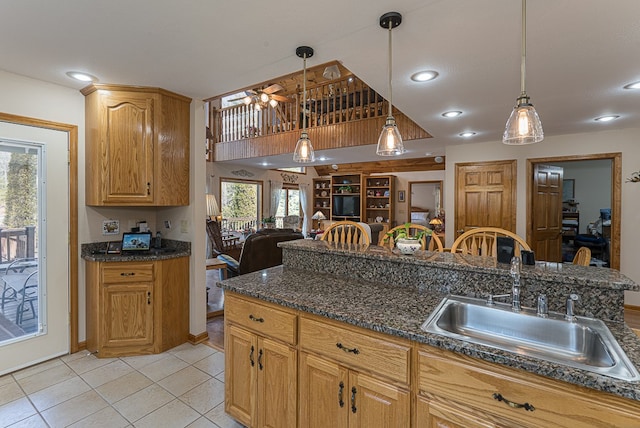 kitchen featuring sink, light tile patterned floors, hanging light fixtures, and a healthy amount of sunlight